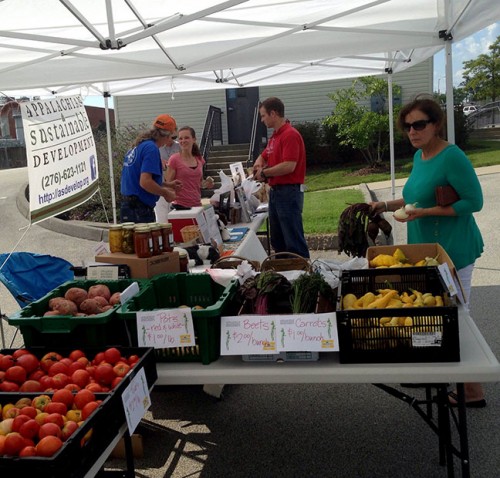 Customers and volunteers at the Eastman farmers market stall
