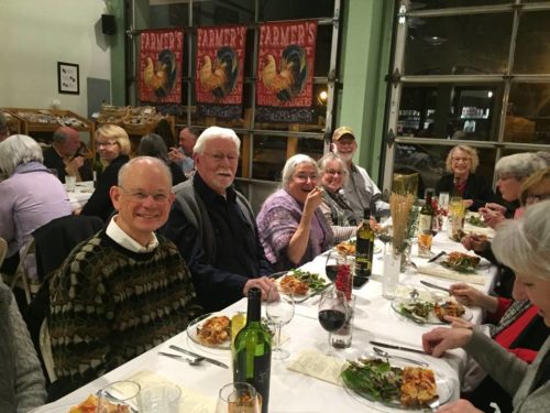 Folks enjoying the food at an Italian themed 100 Mile Dinner.