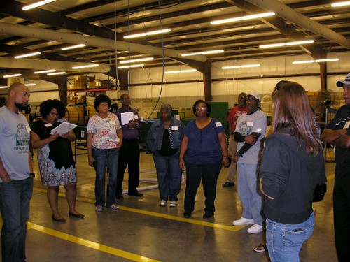 Group of people standing in the Appalachian Harvest warehouse